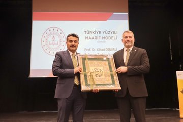First image shows a large auditorium filled with seated audience members in formal attire including suits and ties, viewed from the stage with red chairs and wooden paneling. Second image depicts a man in a dark suit with tie speaking into a microphone on stage, standing near banners for educational organizations and a screen. Third image captures the auditorium with audience seated and a man in suit speaking on stage from a side angle. Fourth image features two men in suits holding a green ornate plaque on stage, with a projection screen displaying event title Türkiye Yüzyılı Maarif Modeli and names Prof. Dr. Cihad Demirli and others.
