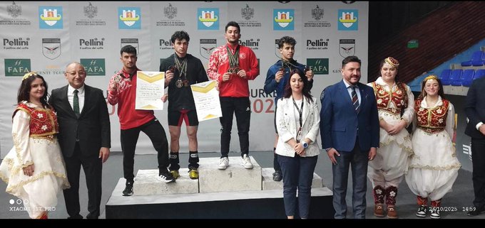 Group of eight people including young male athletes in athletic wear holding gold, silver, and bronze medals on a podium with Turkish and Albanian flags, event banners reading PELLINI and DURRES 2025 in background. Single young male athlete with curly hair wearing black tracksuit and medal holding certificate and gold medal on platform with EWF and Turkish Weightlifting Federation logos, Durrës 2025 banner behind.
