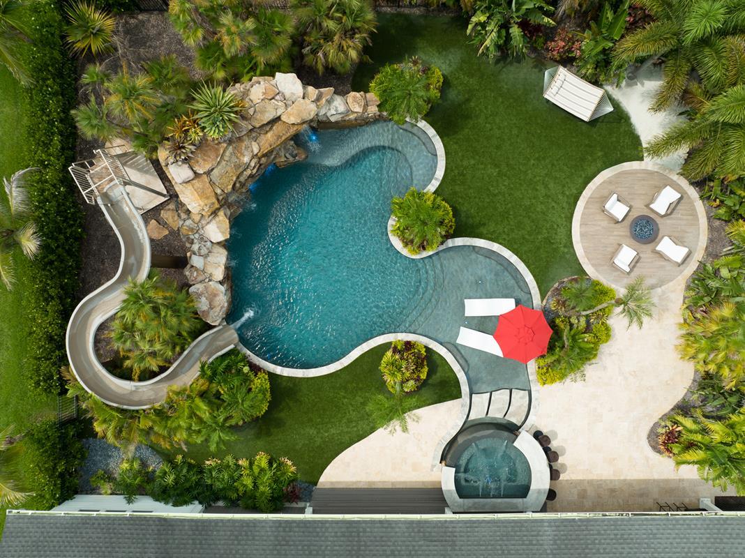 This backyard has a huge grotto, a waterslide, a big elevated spa with a swim-up bar, a sun shelf area, and a big swimming and jumping play area. This place is laid out for entertaining.

#insanepools #lucaslagoons #pool #poolbuilders #backyard #luxurylife #waterslide