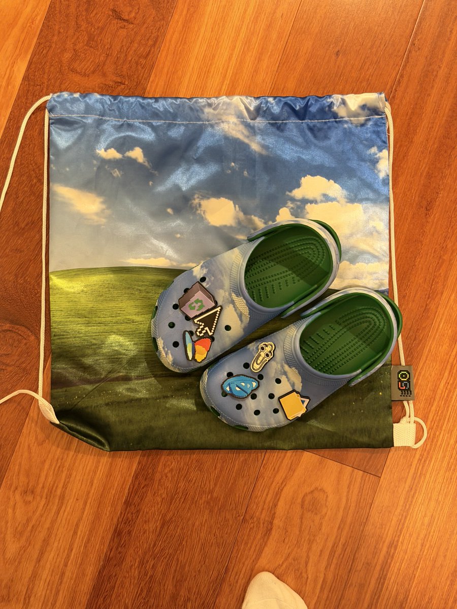 film_girl's tweet image. I’m not promising I’ll wear them all day, but I did bring the Windows XP Crocs to #GitHubUniverse as always, Barry is to blame!
