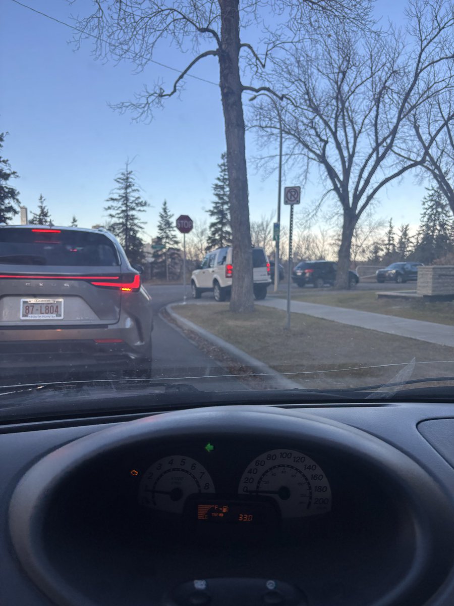 _maitw's tweet photo. Hey @CityofEdmonton have you ever considered putting a traffic light at the intersection of Saskatchewan Drive and 101st NW? 
This person behind me got tired of waiting to turn right (all four cars ahead of them were turning left) and they drove on the literally sidewalk to turn https://t.co/2PUxBT5Lbv