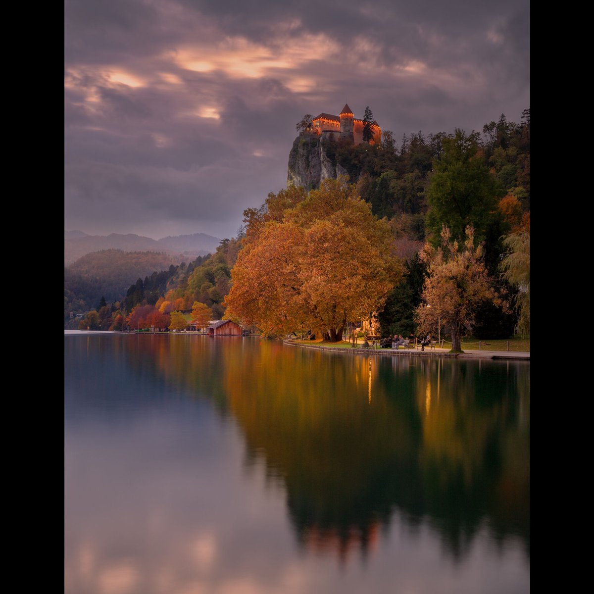 In the hush of evening’s fall, the castle gleams it's light, a crown upon the tranquil night. Golden trees lean gently toward the lake, their shimmering reflections dreaming in Bled’s embrace.

Join me next year: phototours.in/slovenia-a

#creativephotoadventures #PhotoWorkshop