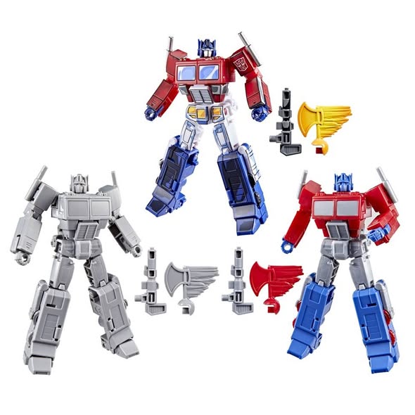 Hasbro introduced the exclusive Spotlight Optimus Prime 3-Pack at Lucca Comics and Games 2025, featuring three variants of the Deluxe Class Devastation Optimus Prime figure: a grey CAD model, an unpainted test shot prototype, and the fully painted final product, all using Studio