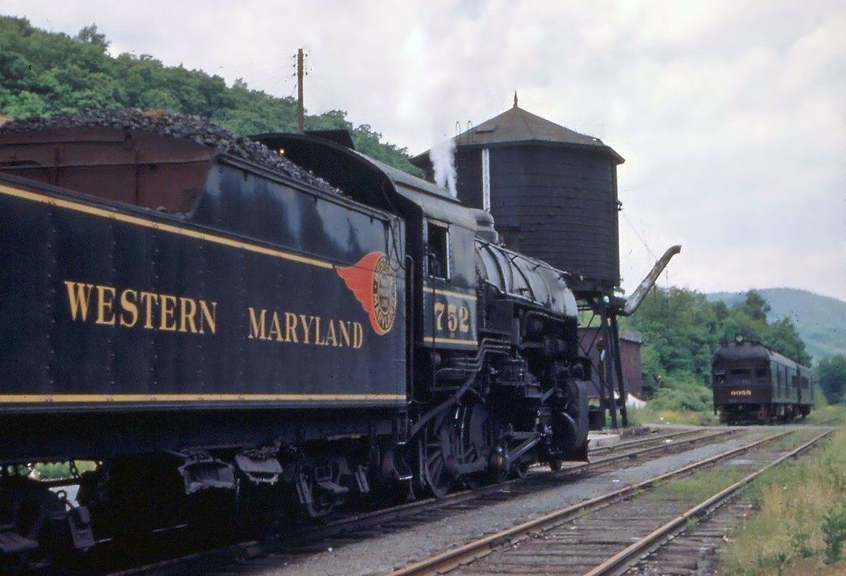 Western Maryland 2-8-0 #752 sits in front of the depot at the end of the Durbin Subdivision in Durbin, WV with what is probably the local from Elkins. The Chesapeake &amp; Ohio connection can be seen in the background comprising a Doodlebug (#9055) and what appears to be a combine.