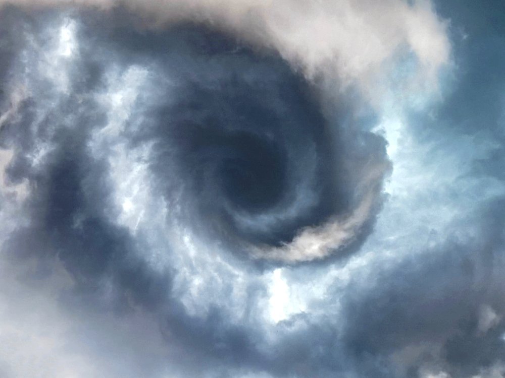 It's pretty incredible how quickly a tornado can develop. The first photo, taken at 5:35 PM, shows a slowly rotating lowering of clouds attached to a boundary. Just five minutes later in the second photo, the tornado touched down about half a mile to my west, with debris lofted.
