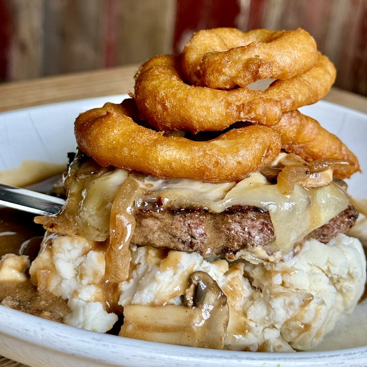 Weekend Special! The B-Side Burger Stack. We took a fresh ground angus beef patty, topped it with melting Swiss, put that over a pile of creamy mashed potatoes,   smothered it all in a mushroom onion gravy, and then crowned it with a stack of crunchy onions. G'night!