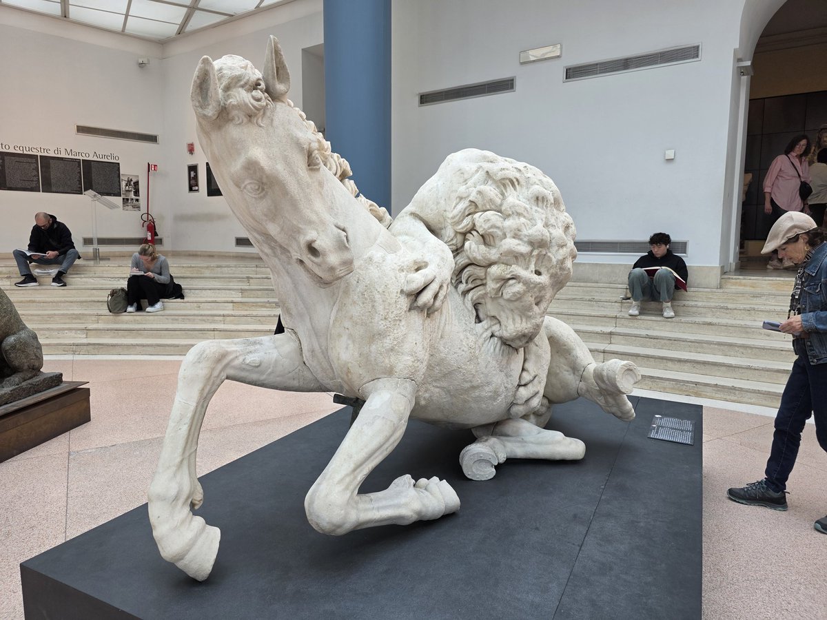 Sculpture of a lion killing a horse to eat it.