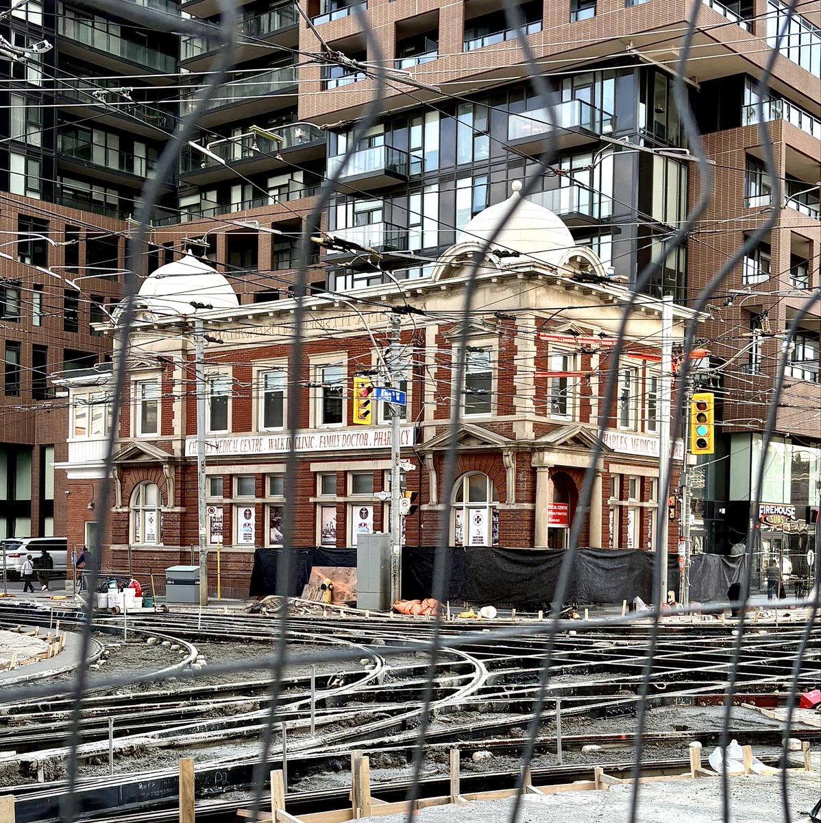 One of the wilder views I’ve come across lately. 

- The former Bank of British North America snagged in maximum security fencing at Dufferin and King W.