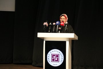 First image shows rows of attendees in formal attire seated in an auditorium with wooden walls Turkish flags and a table with flowers at the front. Second image depicts a woman in headscarf speaking at a podium with microphones and a university logo on the stand against a dark curtain backdrop. Third image features a man in suit at a podium with microphones in front of a screen displaying event title Calisma Yurdunda Din Ogrenimi Vizyonu Turkiye 31 Ekim-17:00 Saat 09:00-17:00 and logos. Fourth image displays a group of officials including men in suits and women in headscarves seated on stage with microphones and flowers in front of an audience.
