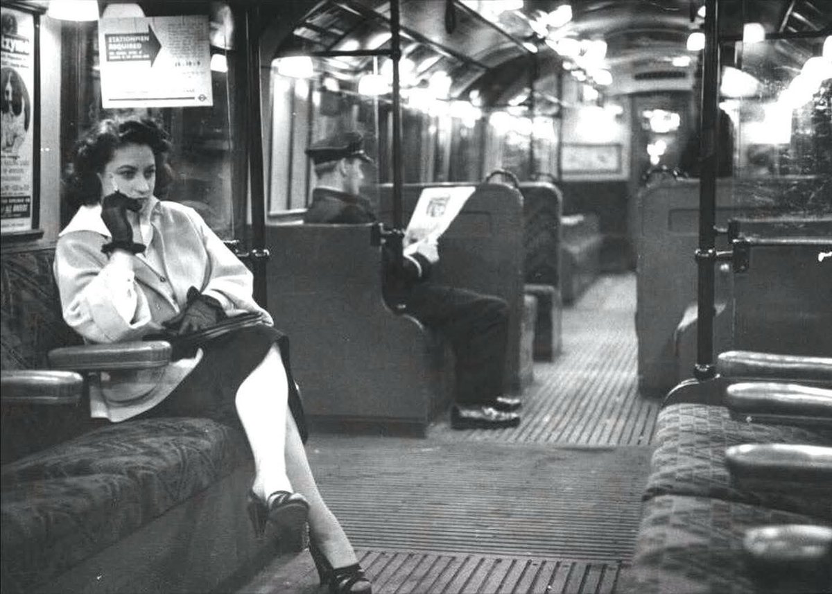 Can you imagine a London underground like the one in this photograph by Bert Hardy in 1952 that's adorned with charming lampshades, wooden floors, nice seats, and most of all, a calming atmosphere? <a href="/Lost___London/">Lost London</a>