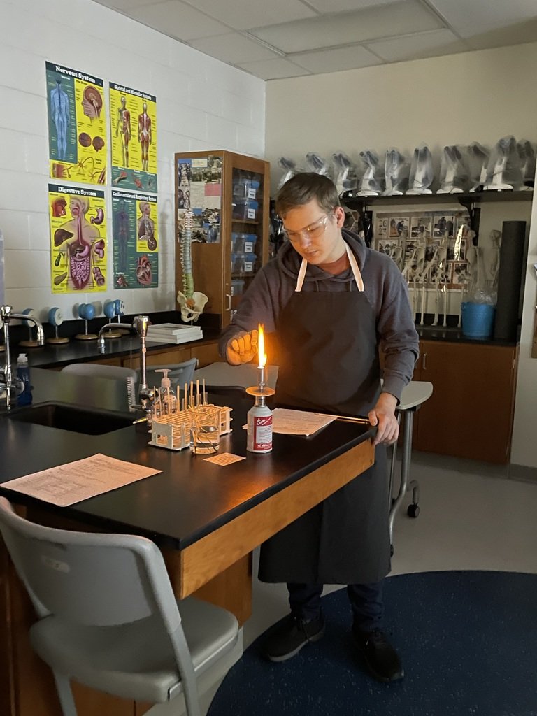 Mrs. Dubois's Chemistry class conducted flame tests to determine an unknown metal salt by examining the photons released after heating.