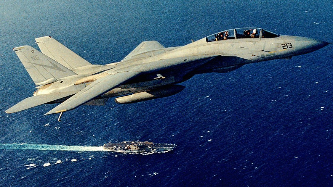 A gorgeous view of an F-14 from VF-24 “Fighting Renegades” cruising above USS Ranger (CVA-61). Did you know that VF-24 was the first Tomcat squadron to drop air-to-ground ordnance? They began testing the “Bombcat” at NAS Fallon in November 1990-91.