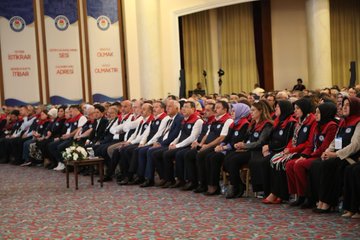 Stage setup with green backdrop displaying Arabic text quotes and white decorative borders man in suit and cap seated at table with microphone another image shows blue stage with 20 Turkiye Bulusmasi banner flags podium with Mesut oner text man in red white vest speaking at podium with flowers below third image depicts row of formally dressed men and women some in vests headscarves seated in auditorium with banners for Istanbul Adana Adiyaman branches and Turkish flags fourth image shows similar group of attendees clapping hands raised in applause with banners for Istanbul Adana Adiyaman branches flowers on table.