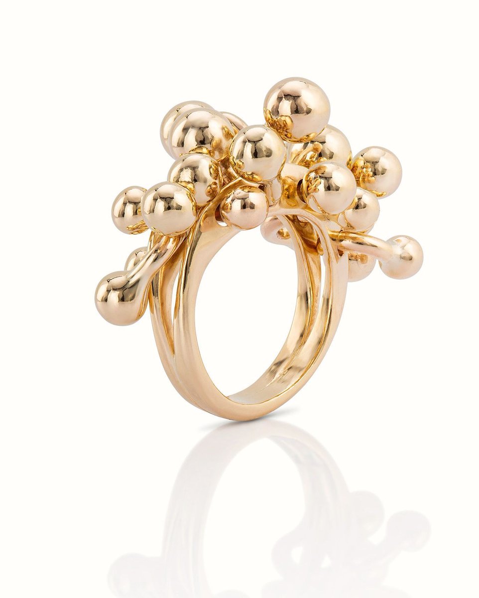 A design revival of what I love - playfulness, the uncompromising and the freedom to let creativity flow. The Molecule Ring is handcrafted in solid gold &amp; each molecular element is designed to move and respond in rhythm with the wearer - a dialogue between structure and motion.