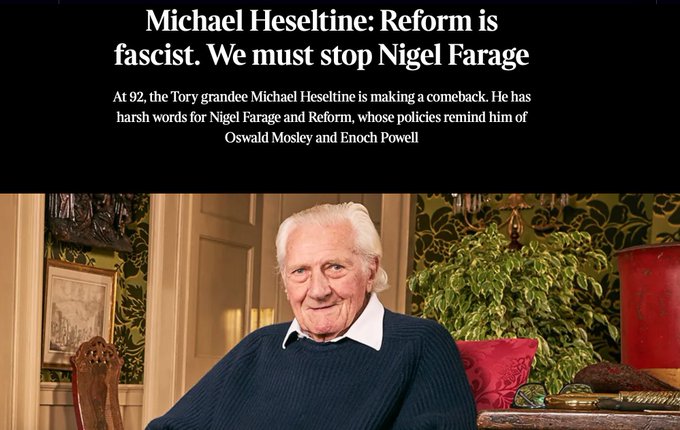 Elderly man with white hair and glasses wearing a green sweater sits in an ornate room with green patterned wallpaper portraits on walls and a red chair nearby. Newspaper headline overlay reads Michael Heseltine: Reform is fascist. We must stop Nigel Farage at any cost. Harsh words for Nigel and Reform which make him reminiscent of Oswald Mosley and Enoch Powell.