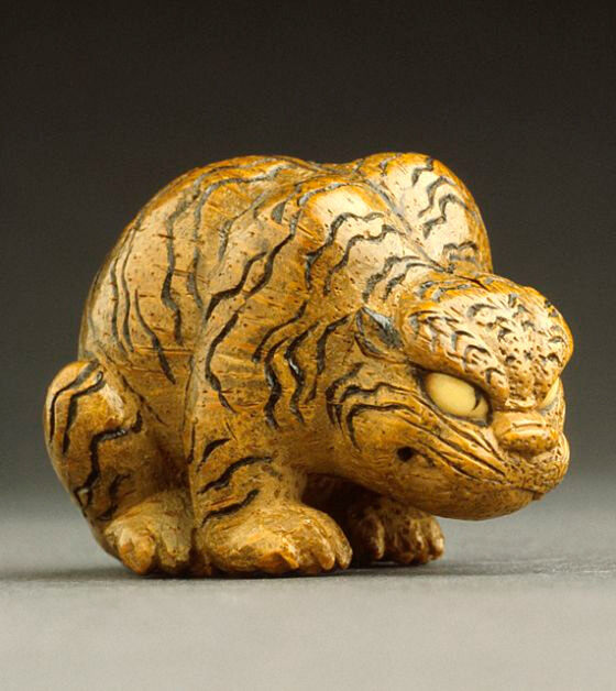 Crouching Tiger. Artist: Sekiran. Culture: Japan. Date: mid to late 19th century AD. Object type: netsuke. Medium: bamboo with inlays. Dimensions: 4.1 x 3.4 x 3.1 cm. Collection: Raymond and Frances Bushell Collection. Los Angeles County Museum of Art, Los Angeles. 

This tiger