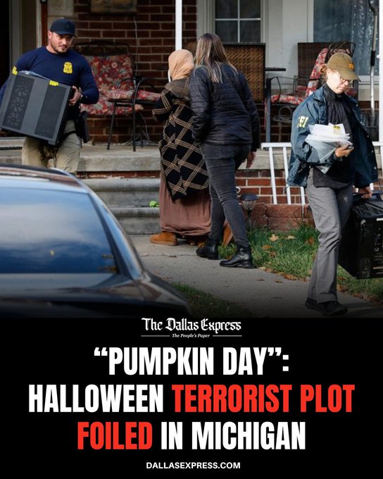 Law enforcement officers in blue uniforms and caps carry equipment boxes and documents while detaining several individuals including a woman in a headscarf and coat and a man in a cap outside a brick house with white porch furniture and a parked car nearby. The scene depicts an early morning raid at a residential property in a suburban setting with green lawn and steps leading to the entrance.