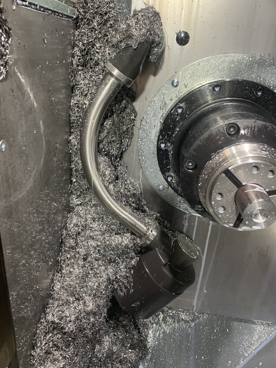 MunkworksMike's tweet photo. Need to figure out a better chip solution. This is after a 6 hour run that does most of the roughing with an Endmill since the parts are off center. https://t.co/poCjcFFA47