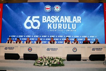 First image shows a man in a white shirt and red-and-navy vest holding a microphone while speaking on a stage with a blue backdrop featuring white text for 65. Presidents Council and Antalya 2025 along with rose emblems. Second image depicts a row of men in suits seated behind a long table on a stage with a large blue screen displaying 65 Presidents Council and Turkish flags flanked by flower arrangements. Third image captures a large group of men mostly in suits and vests standing together on a stage in front of a blue screen with the event title 65 Presidents Council Antalya 2025 and red banners. Fourth image presents a diverse group of about 30 people including men and women in formal attire such as suits and dresses posing in a row before a blue backdrop announcing 2025/2026 New Term Presidents with stage lighting.
