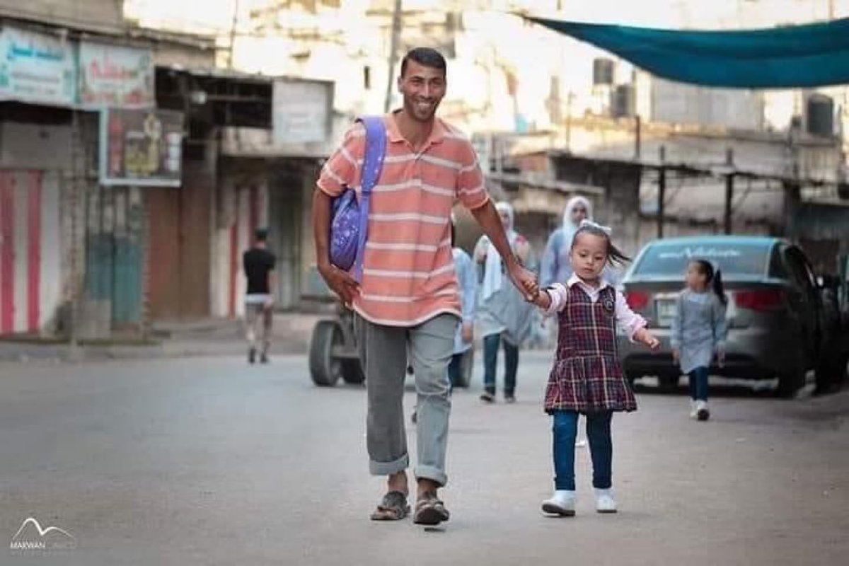 Do you remember this photo from Al-Maghazi refugee camp in central Gaza — a father walking his daughter to her first day of school?
That man was murdered by Israel in front of his children.