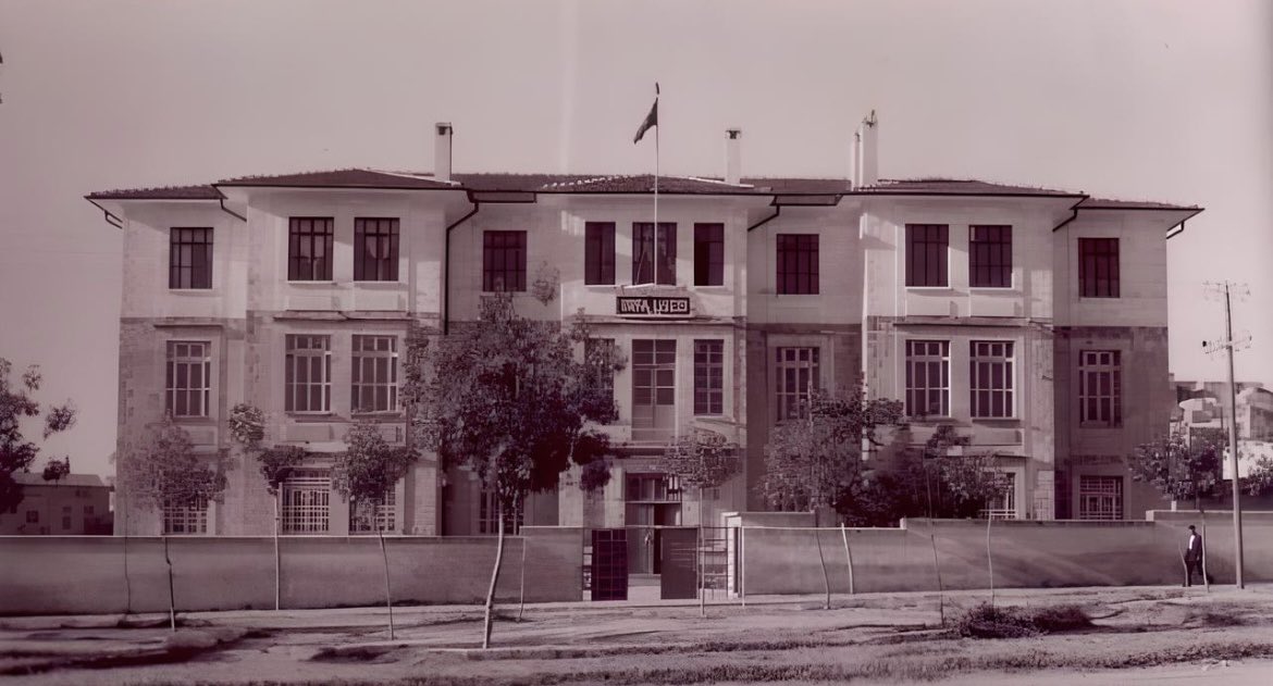 1930’lu yıllarda, bugün halk arasında ‘Asfalt Cadde’ denilen Vali İzzet Caddesi, solda Vatan ilkokulu. İlerisinde, o zaman Hükümet Konağıyken önce Ortaokula ve  bir kat eklenerek 1946’da Urfa Lisesine çevrilen bina.