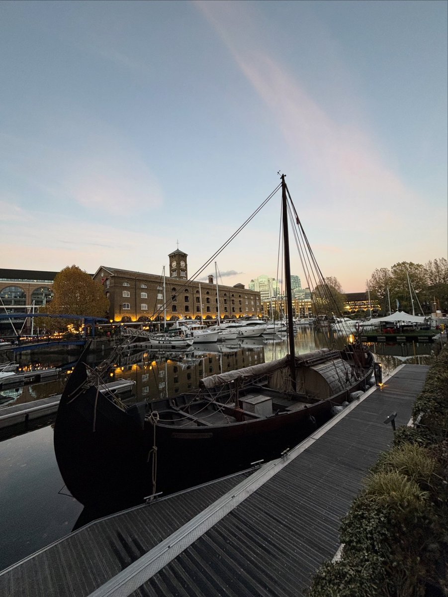 Dusk at the docks. The sunsets over the Viking ship replica, Saga Farmann and the docks
