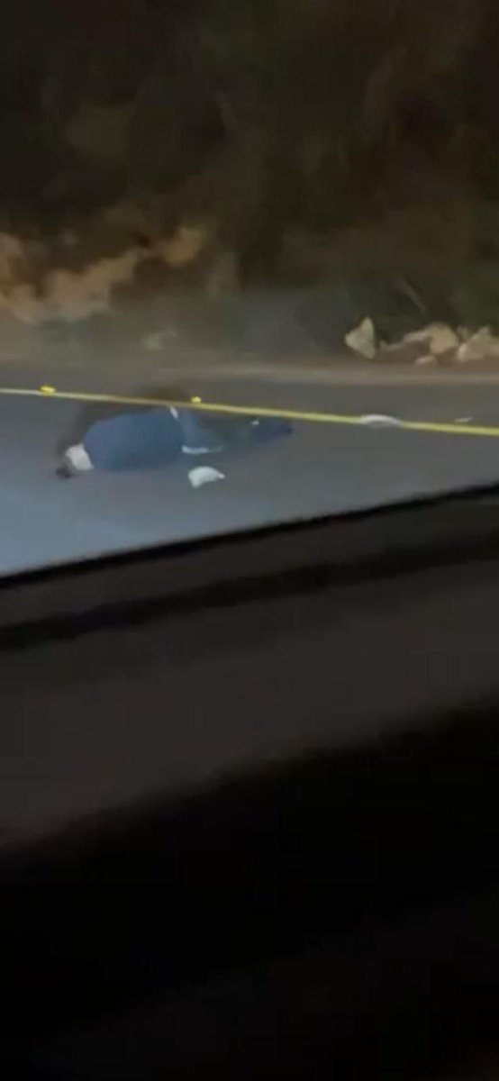 First image depicts a young man with short dark hair wearing dark sunglasses, a black Adidas jacket with white stripes, blue jeans, and sneakers, sitting on a yellow plastic chair outdoors surrounded by greenery, plants, and a metal pole in the background. Second image shows a nighttime roadside scene with a dark asphalt road, scattered rocks, some yellow tape, and a dark figure lying on the ground near the edge, with dim lights and shadows in a rural or semi-urban setting.