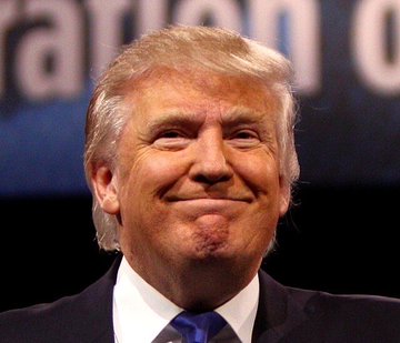 First image shows an elderly man with light hair, smiling with pursed lips, wearing a dark suit, white shirt, and blue tie, standing against a dark background. Second image depicts a middle-aged man with a dark beard, serious expression, dressed in a gray checkered suit, white shirt, and blue tie, positioned among other suited men in a light beige setting.