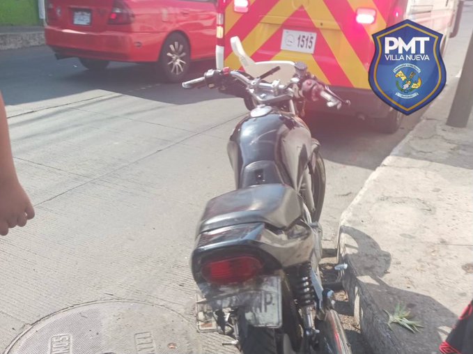 Street scene showing a black motorcycle positioned behind a red van with emergency lights activated and yellow hazard stripes on its rear a police vehicle with PMT VILLANUEVA emblem visible in the foreground and background cars parked nearby under daylight conditions