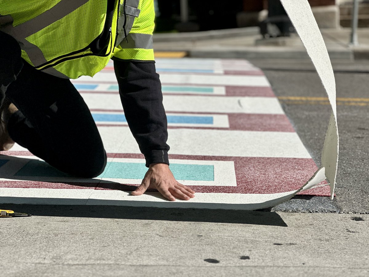 JaxiePidgeon's tweet photo. The streets of Downtown Nashville are a bit brighter this morning! Artists are installing a new, permanent creative crosswalk at Fifth Ave and Broadway that’s inspired by the iconic stained- glass windows of the Ryman Auditorium. 🎨✨

@WKRN | @theryman | @GallagherAsphal https://t.co/zYCszicM7X