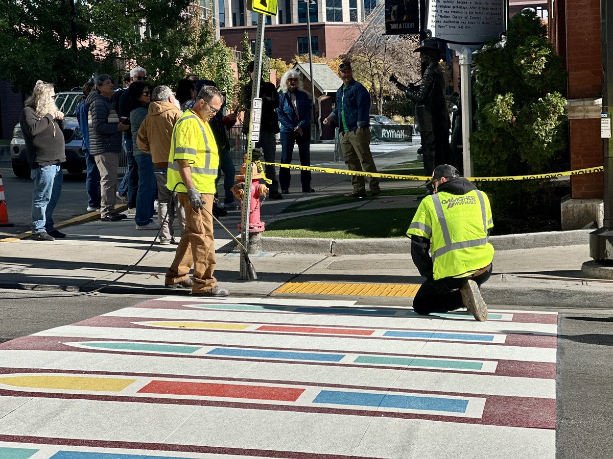 JaxiePidgeon's tweet photo. The streets of Downtown Nashville are a bit brighter this morning! Artists are installing a new, permanent creative crosswalk at Fifth Ave and Broadway that’s inspired by the iconic stained- glass windows of the Ryman Auditorium. 🎨✨

@WKRN | @theryman | @GallagherAsphal https://t.co/zYCszicM7X