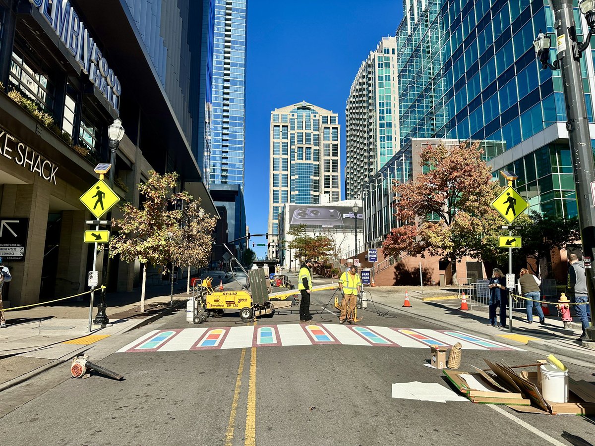 JaxiePidgeon's tweet photo. The streets of Downtown Nashville are a bit brighter this morning! Artists are installing a new, permanent creative crosswalk at Fifth Ave and Broadway that’s inspired by the iconic stained- glass windows of the Ryman Auditorium. 🎨✨

@WKRN | @theryman | @GallagherAsphal https://t.co/zYCszicM7X