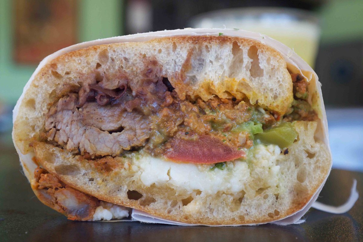 The popularity of Ranchito #50 is no secret 🥪🔥 Filled with a delicious blend of mayo, grilled beef, chorizo, cactus salad, black beans, spicy guacamole and queso fresco – it's a taste sensation! #CooksTortas #RanchitoMagic #FoodieFave