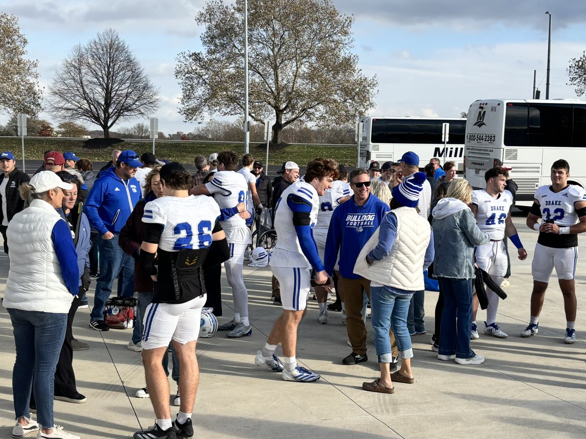 DrakeADHardin's tweet photo. Happy bunch of @DrakeBulldogsFB student-athletes and families celebrating today’s win which clinches at least a share of a 3rd straight @PFLNews championship! Great job, Bulldogs and congrats to @CoachJoeWoodley and staff! #DSMHometownTeam https://t.co/HwHCZSgeGL