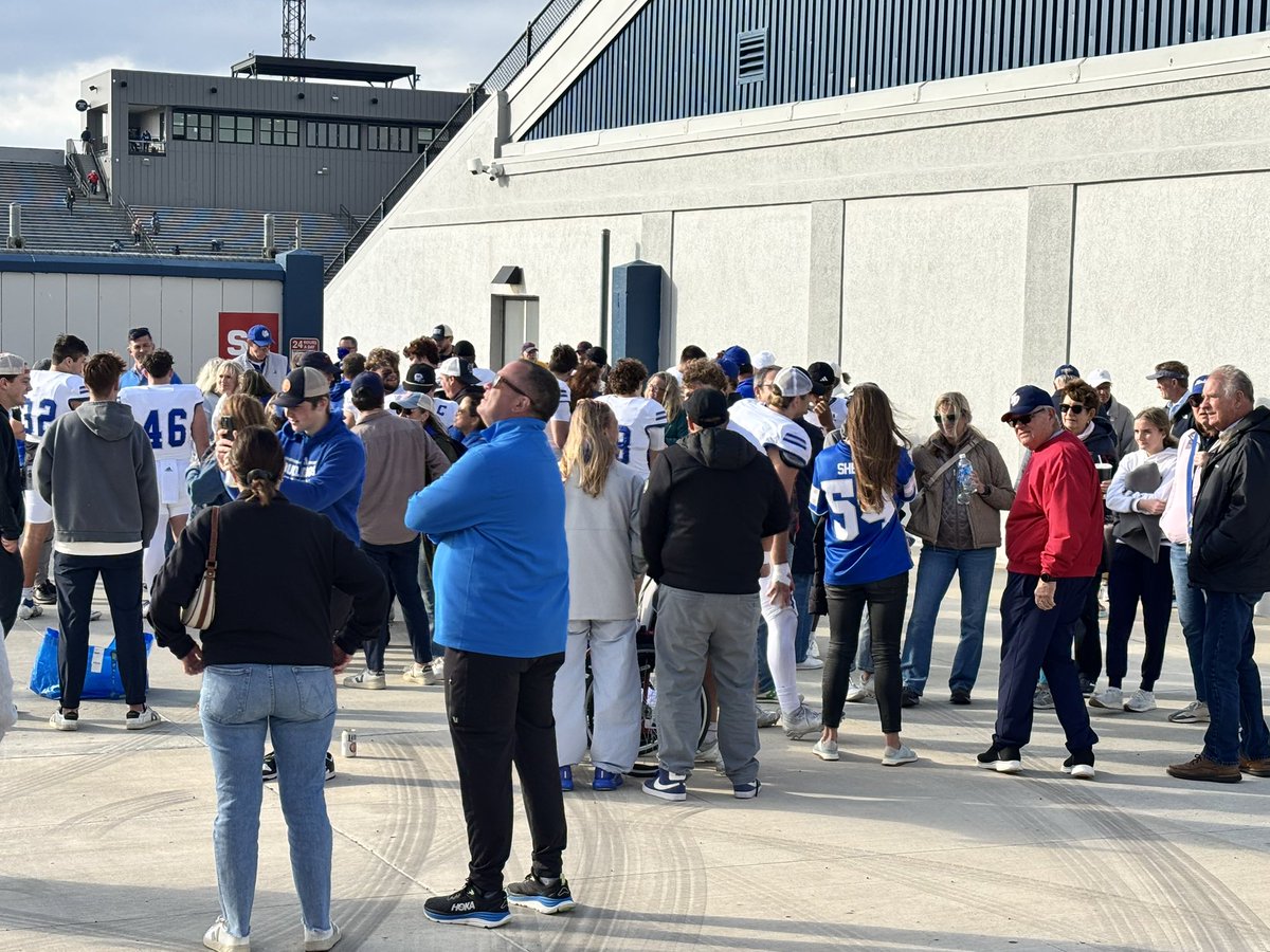 DrakeADHardin's tweet photo. Happy bunch of @DrakeBulldogsFB student-athletes and families celebrating today’s win which clinches at least a share of a 3rd straight @PFLNews championship! Great job, Bulldogs and congrats to @CoachJoeWoodley and staff! #DSMHometownTeam https://t.co/HwHCZSgeGL