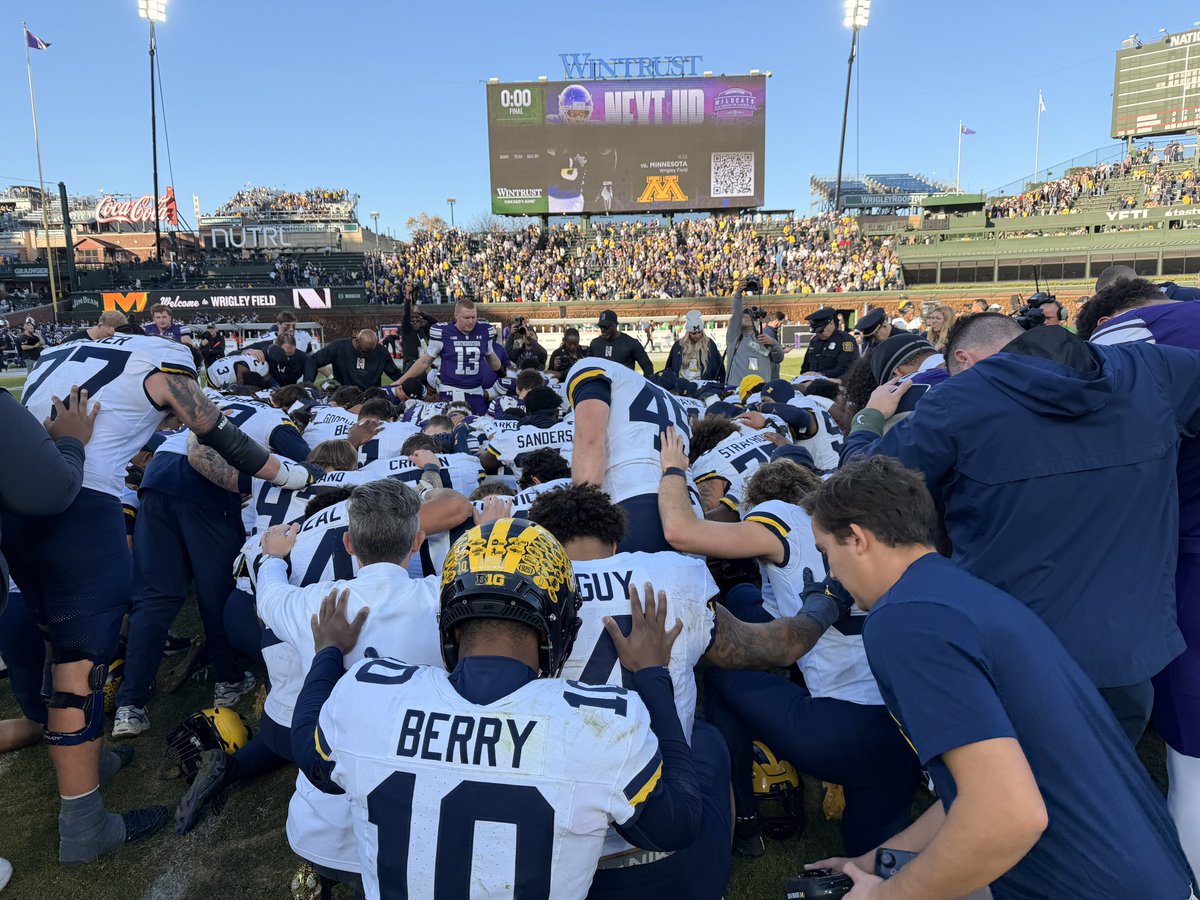 Michigan and Northwestern praying after the game.