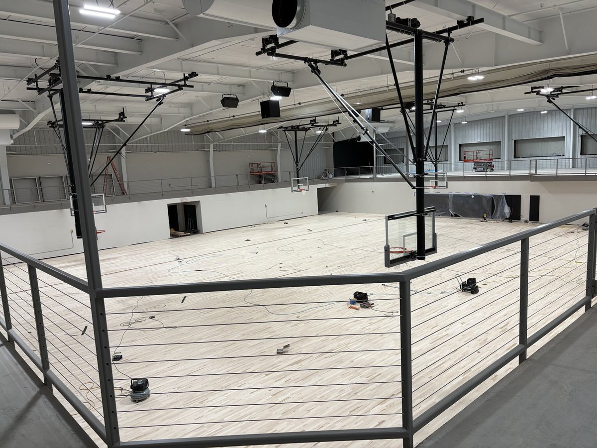 Flooring is down. Windows in the distance installed soon to look into the west gym. The black wall will have a 9’ X 19’ high definition LED board on Alumni Bridge.