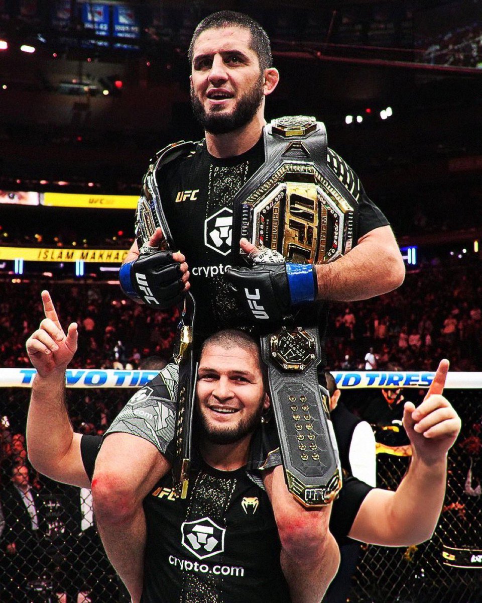 fightpicsgohard's tweet image. Islam Makhachev holding his belts with Khabib Nurmagomedov (2025)