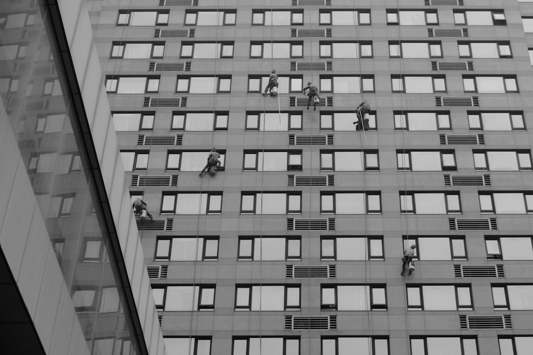 nextedgeaccess's tweet image. A rope access technician working on a tall building]