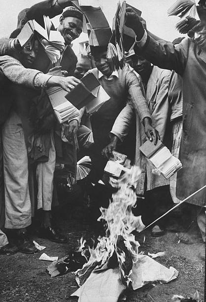 Residents from the township of Sharpeville burn their pass books during a demonstration against government pass laws as part of a day of protest, March 1960. Photo: Terence Spencer