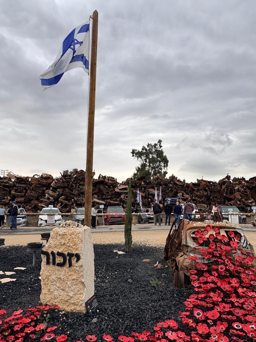“Windflowers Before the Rain”  

Born in love
in the fury of war
by the hands of thousands of volunteers 
to triumph over the massacre of the “Black Shabbat”
and the fallen in its battles

(A translation of the poem at the base of the car memorial to the massacre that took place