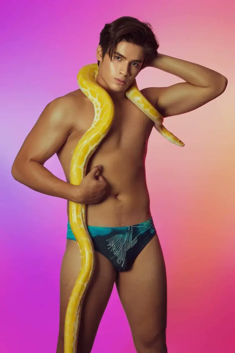 Handsome model boy charms a yellow python... 🍭 🔥 🐍