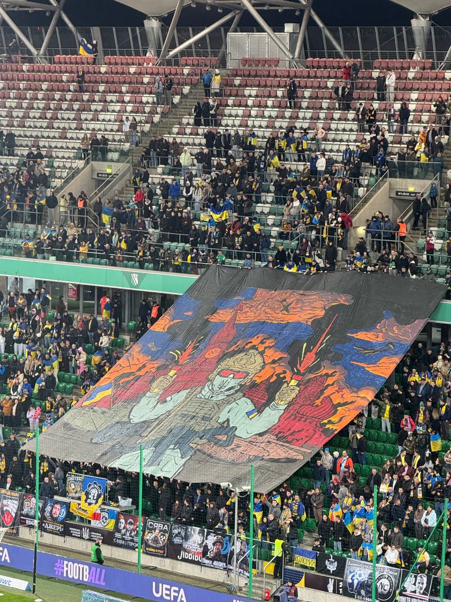 BohuslavskaKate's tweet image. At the Ukraine–Iceland football game, fans unveiled a banner showing a Ukrainian soldier against the backdrop of a burning Kremlin ❤️‍🔥