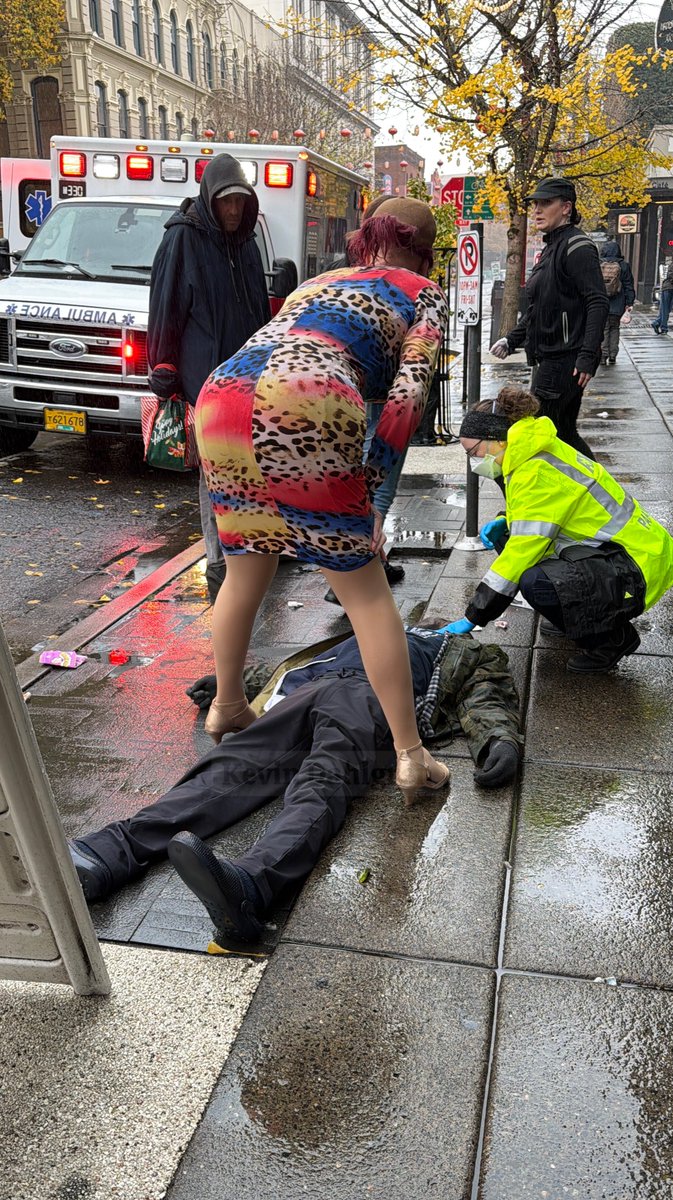 The most Portland photo ever. A female impersonator standing over a man overdosing on fentanyl. I took this photo this afternoon. I witnessed four overdoses in 10 minutes. Three of the four people lived. I’ll post the video tomorrow.