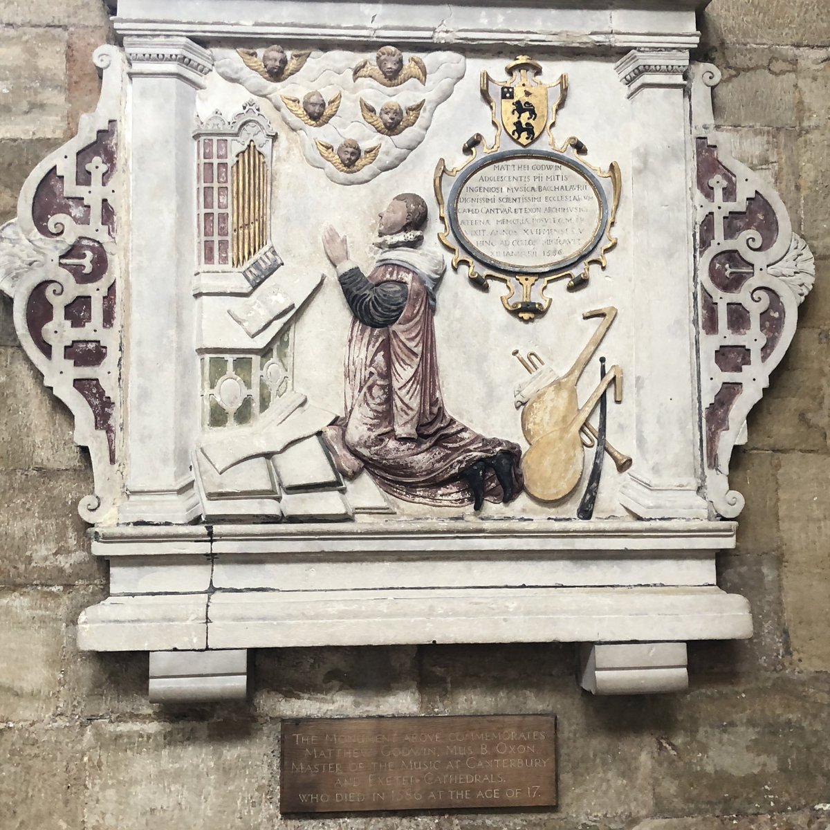 RAGriggsauthor's tweet image. Memorial to young musician Matthew Godwin in Exeter Cathedral. Only 17y and 5m old when he died in 1586. 

The main keys on the small organ are black, the reverse of modern keyboards, as was usual in the 16th century. 

#MonumentsMonday