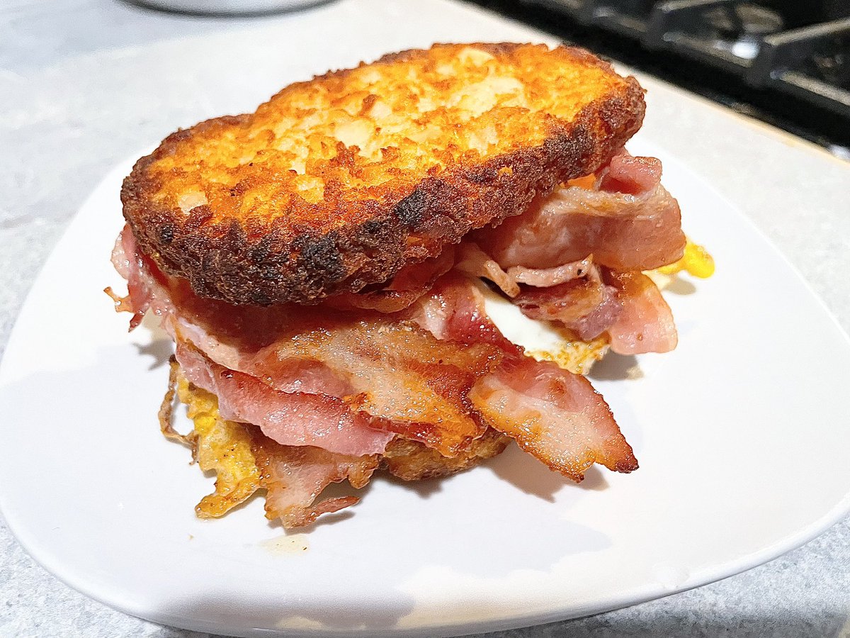 Breakfast sandwich with a twist. Bacon, egg and cheese on air fried hash browns instead of bread.