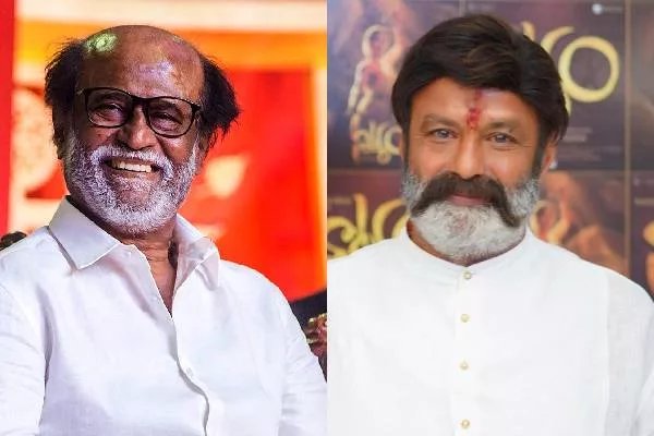 Side-by-side portrait of two elderly Indian actors. Left side shows Rajinikanth with white hair, glasses, smiling, wearing a white shirt against a red background. Right side shows Nandamuri Balakrishna with a white beard, wearing a white kurta, against a golden background with Telugu text.