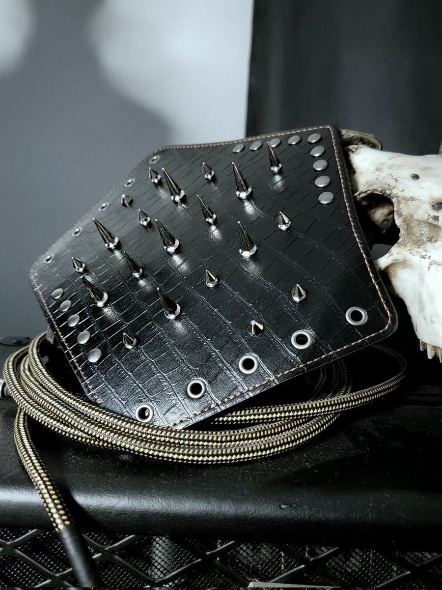 Tombthread666's tweet image. Tombthread Vesper Spines - Arm Guard - pair
Handcrafted gothic armor for the modern dark performer.
Made from black crocodile-pattern leather, set with conical steel spikes and reinforced rivets.
Laced back for adjustable fit, detailed with contrasting dark-bronze stitching.