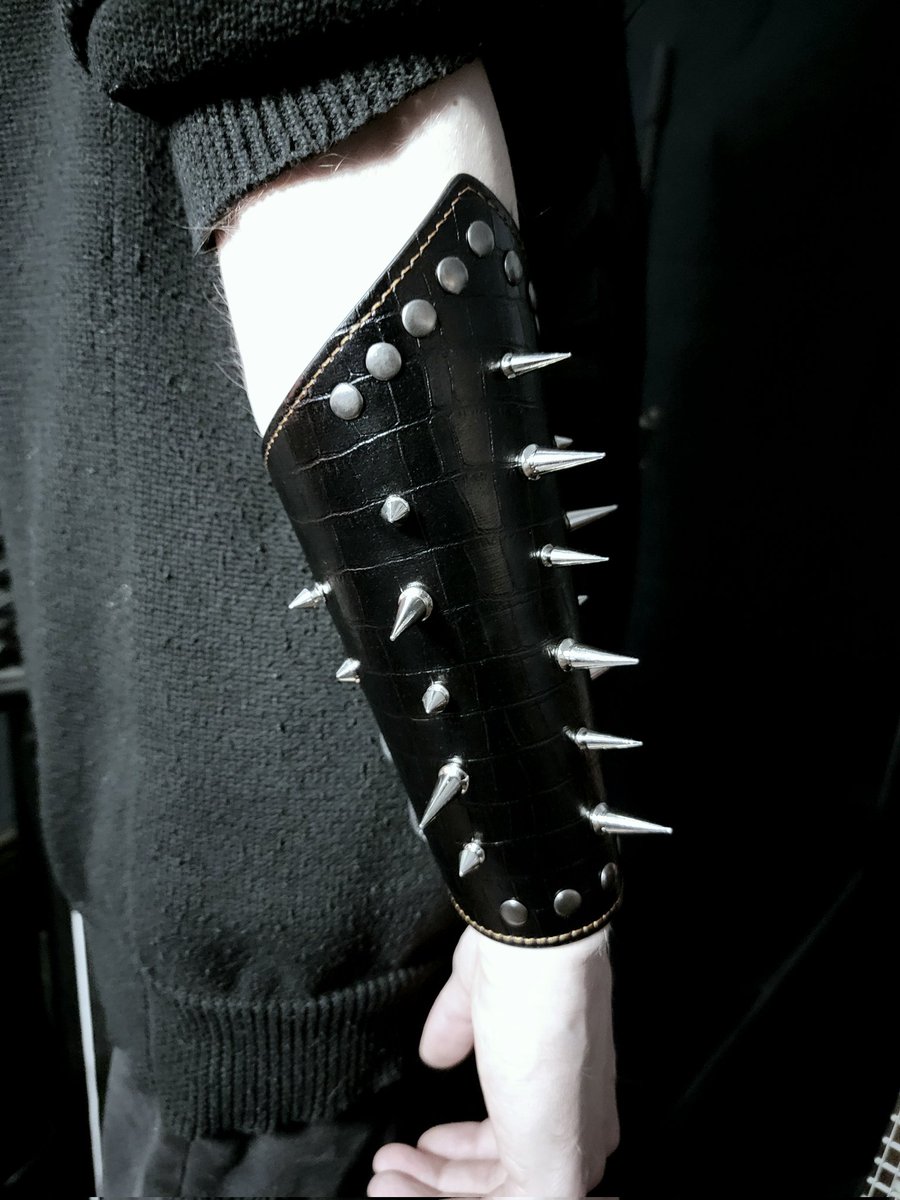 Tombthread666's tweet image. Tombthread Vesper Spines - Arm Guard - pair
Handcrafted gothic armor for the modern dark performer.
Made from black crocodile-pattern leather, set with conical steel spikes and reinforced rivets.
Laced back for adjustable fit, detailed with contrasting dark-bronze stitching.