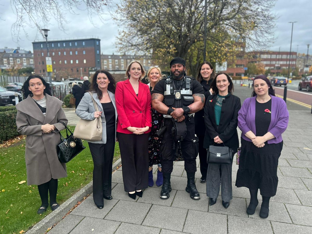 The Darlington nurses standing with Ade, their security guard